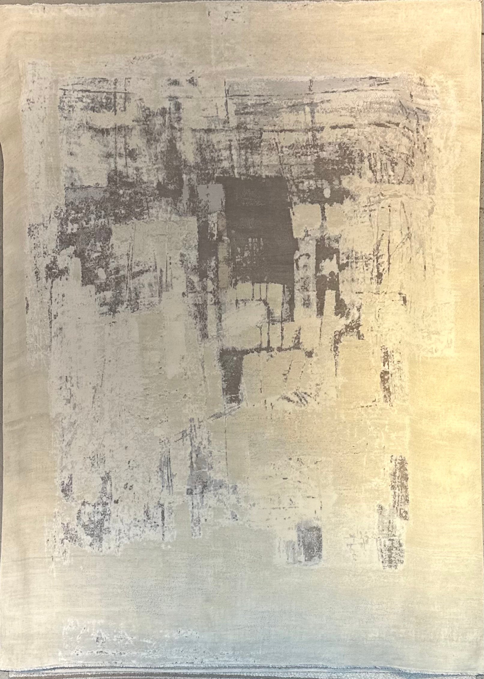 Abstract rug with dark grey and white brush strokes on a beige background